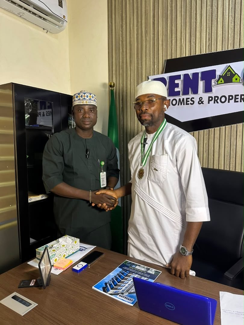 Engr. Emmanuel C. Ibeazor, Chairman and CEO of Pentagon Homes and Properties Limited, shaking hands with a representative of the Dream Youth Center Abuja in the Pentagon Homes office