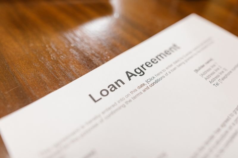 Mortgage application paperwork and a calculator