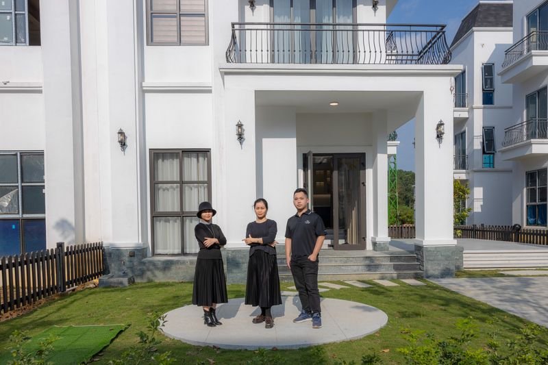 A family in front of their new home